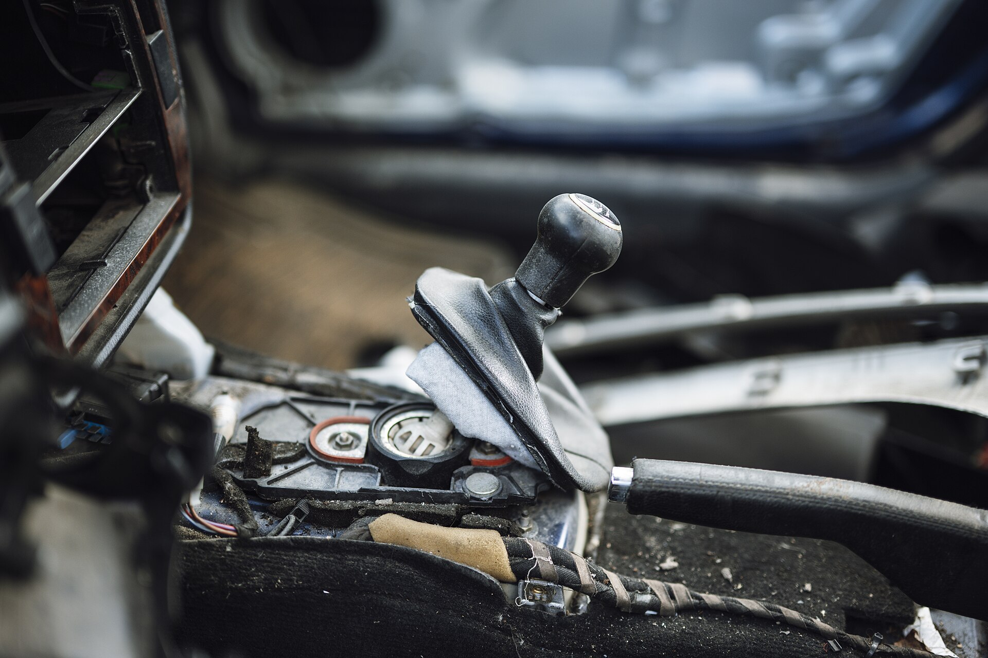 Car gear shift in an old vehicle interior showing signs of wear and tear during a repair session in an auto shop.jpg — illustrating What Is a Magnetic Parts Tray and Why Mechanics 