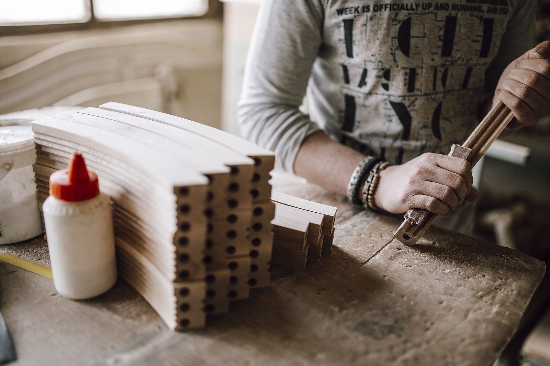 Woodworking process involves crafting wooden pieces at a workbench.jpg — illustrating What Is a Biscuit Joiner and What Does It Join?